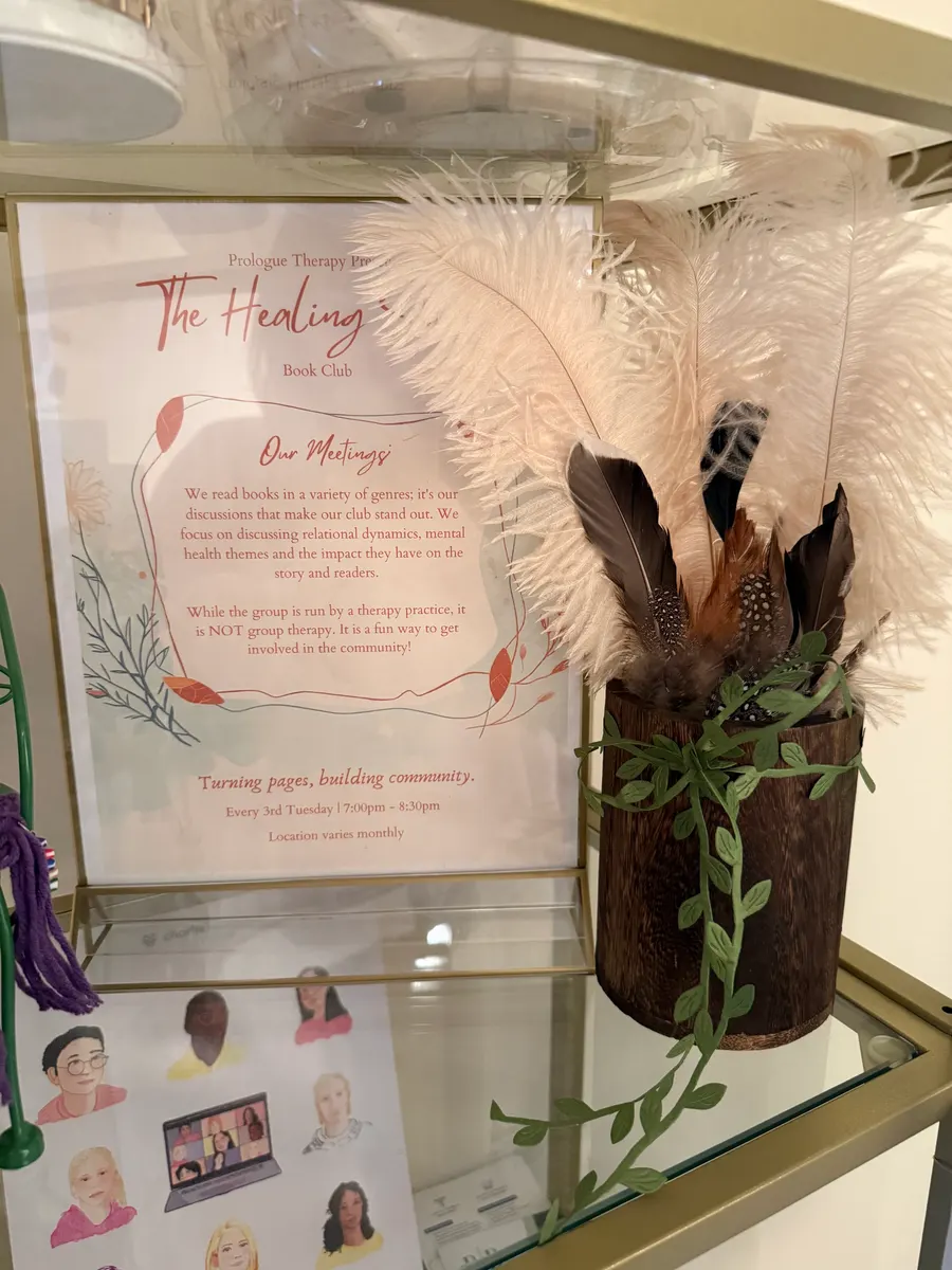 The framed Healing Shelf book club notice on the wall